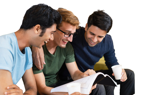 three-fellow-students-reading-textbook-laughing